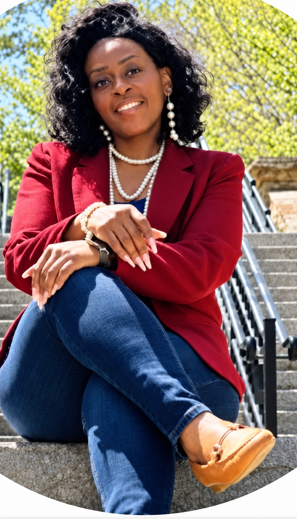 Founder of Before the End™ LLC seated outdoors in a burgundy blazer